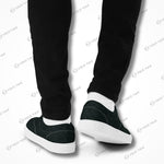 Back view of Edgewalker 2 black canvas sneakers worn with black pants, highlighting their clean and modern design.