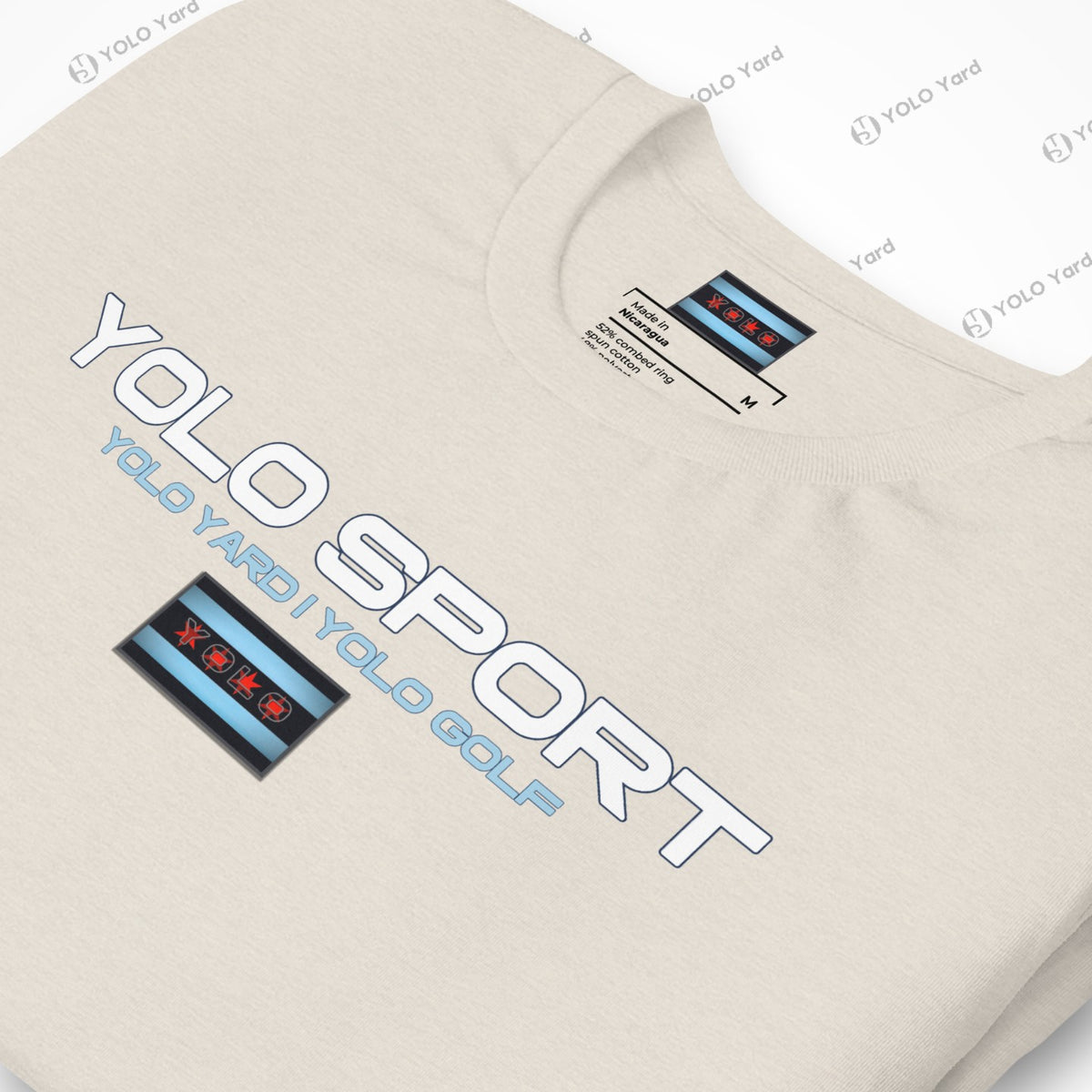 Close-up of a cream YOLO Sport t-shirt showcasing the logo and Chicago flag-inspired design. Soft and breathable fabric.