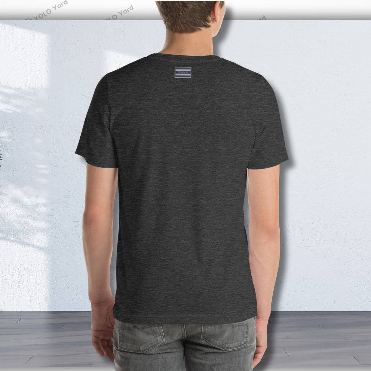 Back view of a dark gray YOLO Sport t-shirt worn by a man. Minimalist design with a small logo on the upper back.