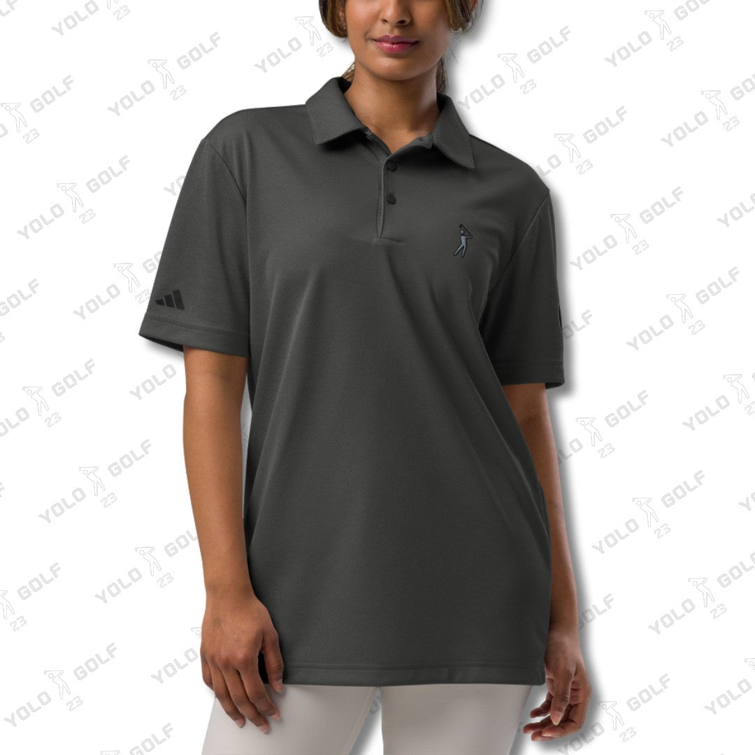 Woman wearing the space-dyed black polo shirt from 