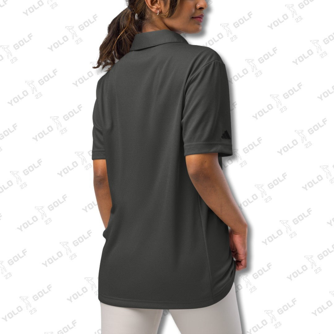 Back view of a woman wearing the space-dyed black polo shirt from 