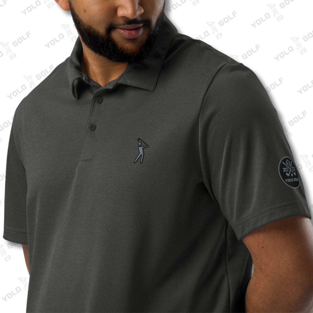 Close-up of a man wearing the space-dyed black polo shirt from 