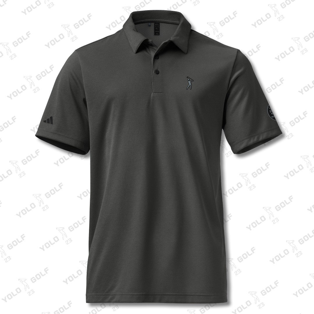 Space-dyed black polo shirt from #YOLO Golf-adidas X Signature Black Edition featuring a sleek design with embroidered logo on the chest.