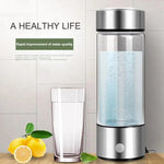 AquaPure Hydrogen Water Bottle with glass of water and lemons, promoting a healthy lifestyle and improved water quality.