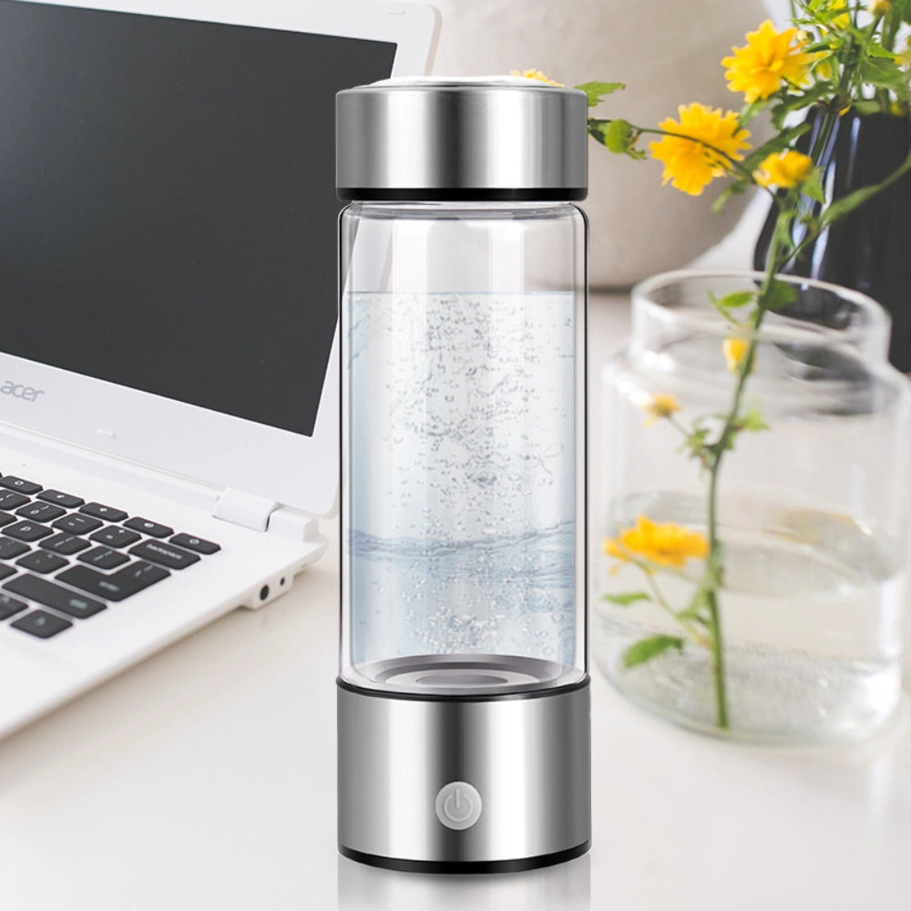 AquaPure Hydrogen Water Bottle on a desk with flowers, blending functionality and aesthetics for a healthy lifestyle.