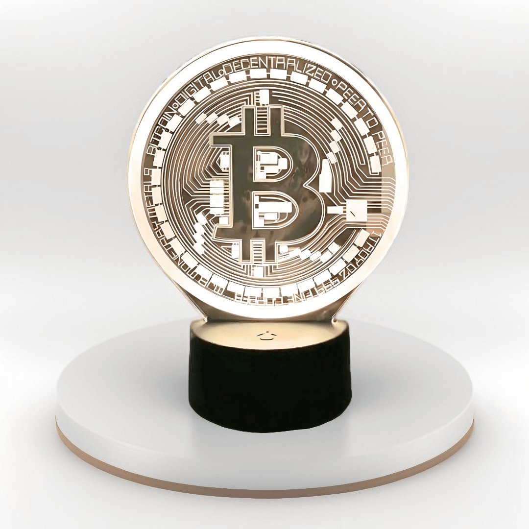 CryptoGlow Bitcoin Beacon 3D LED desk lamp with a glowing Bitcoin design on a black base, perfect for home office decor.