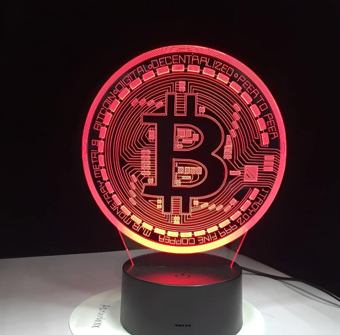 Red-lit Bitcoin 3D LED desk lamp on a black base, a bold and modern statement piece for home or office.