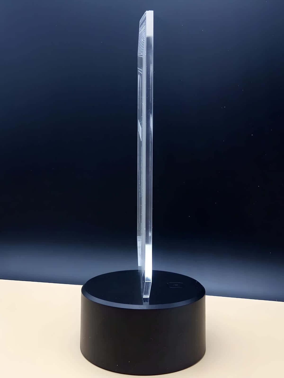 Side view of the CryptoGlow Bitcoin 3D LED lamp, showcasing its slim acrylic design and sturdy black base.