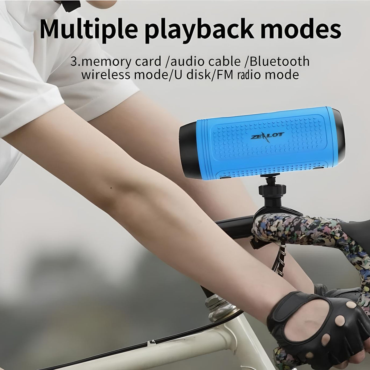 Zealot S1 Bluetooth speaker mounted on a bicycle, demonstrating multiple playback modes including Bluetooth, FM radio, and memory card.