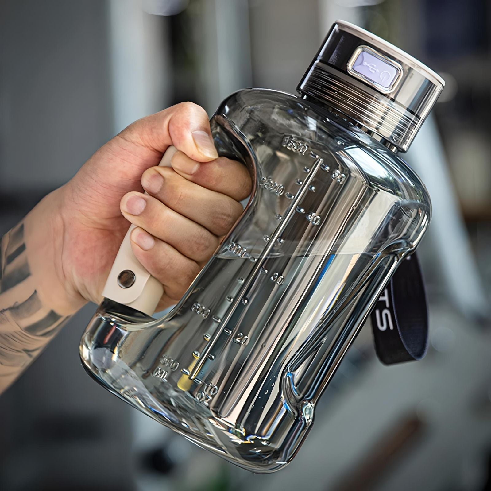 HydroBoost hydrogen water bottle held in hand, showcasing ergonomic design and measurement markings.