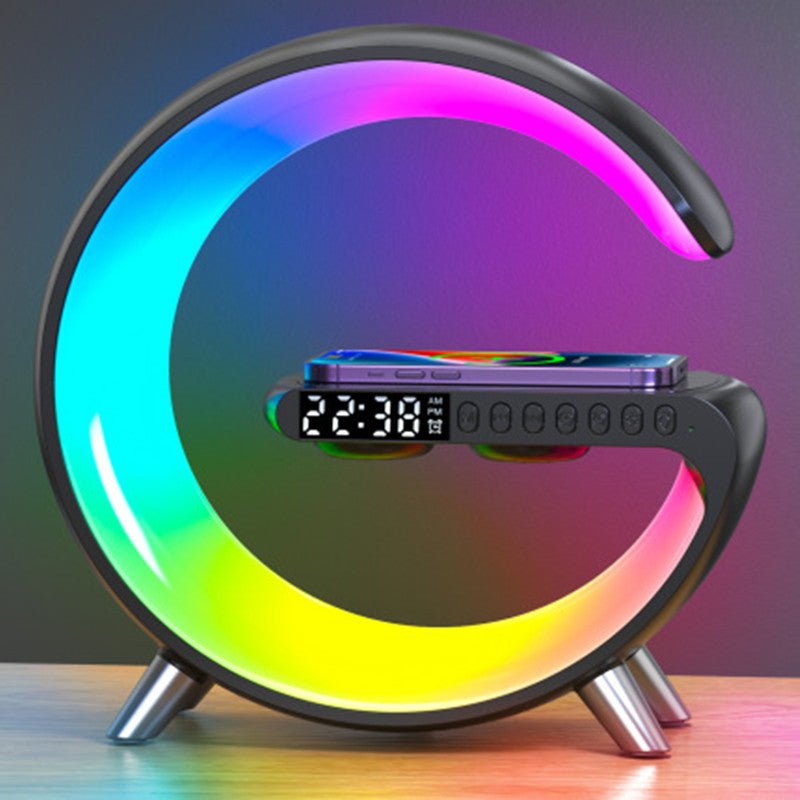 Black G-shaped LED lamp with vibrant multi-color lighting, wireless charging pad, and digital clock display for modern home decor.