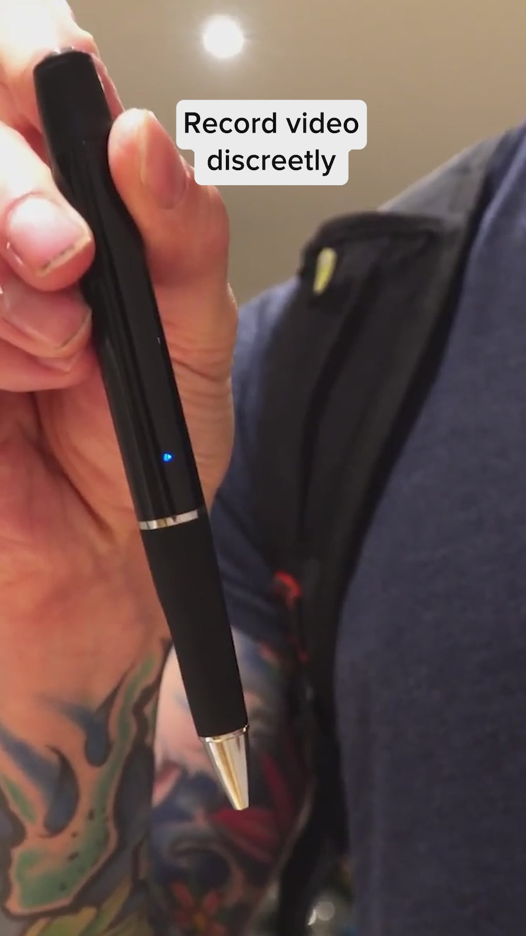 Person demonstrating discreet recording with OmniSmart HD Video Recorder Pen, featuring a sleek black design and LED indicator.