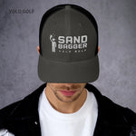 Light gray Sandbagger trucker hat worn by a man, highlighting its 