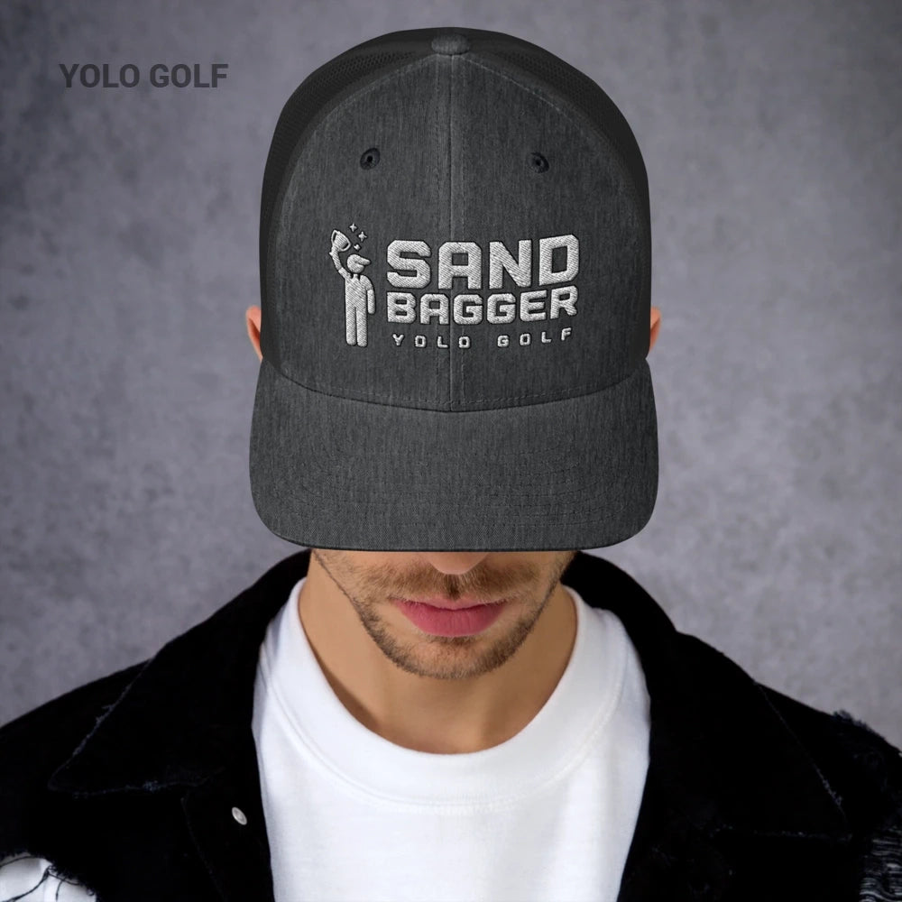 Charcoal gray Sandbagger trucker hat worn by a man, highlighting its 