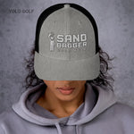 Light gray Sandbagger trucker hat worn by a woman, highlighting its 