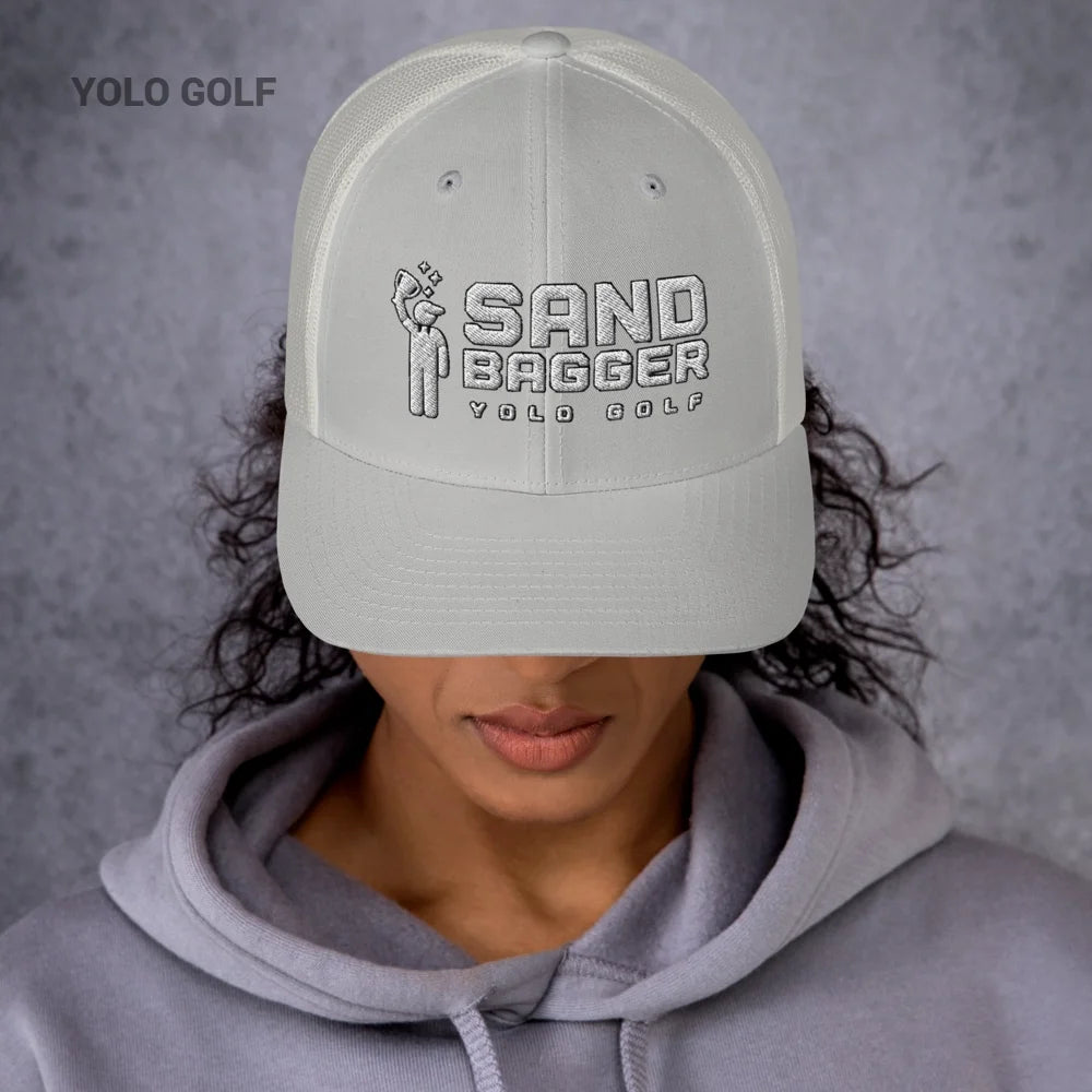 Green Sandbagger trucker hat worn by a man, showcasing its 