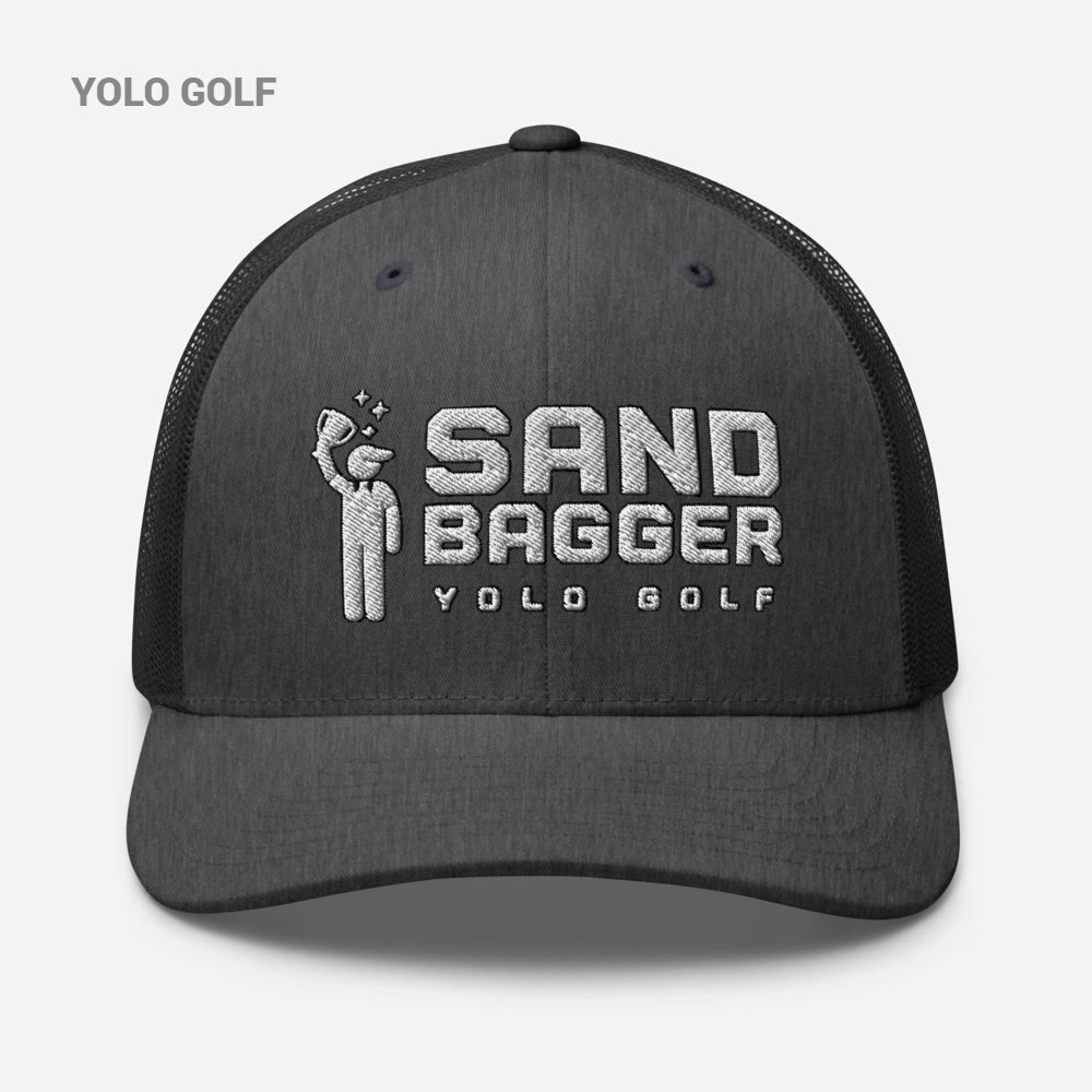 Charcoal gray Sandbagger 6-panel trucker hat with #YOLO Golf embroidered logo, featuring breathable mesh back and adjustable snapback closure.